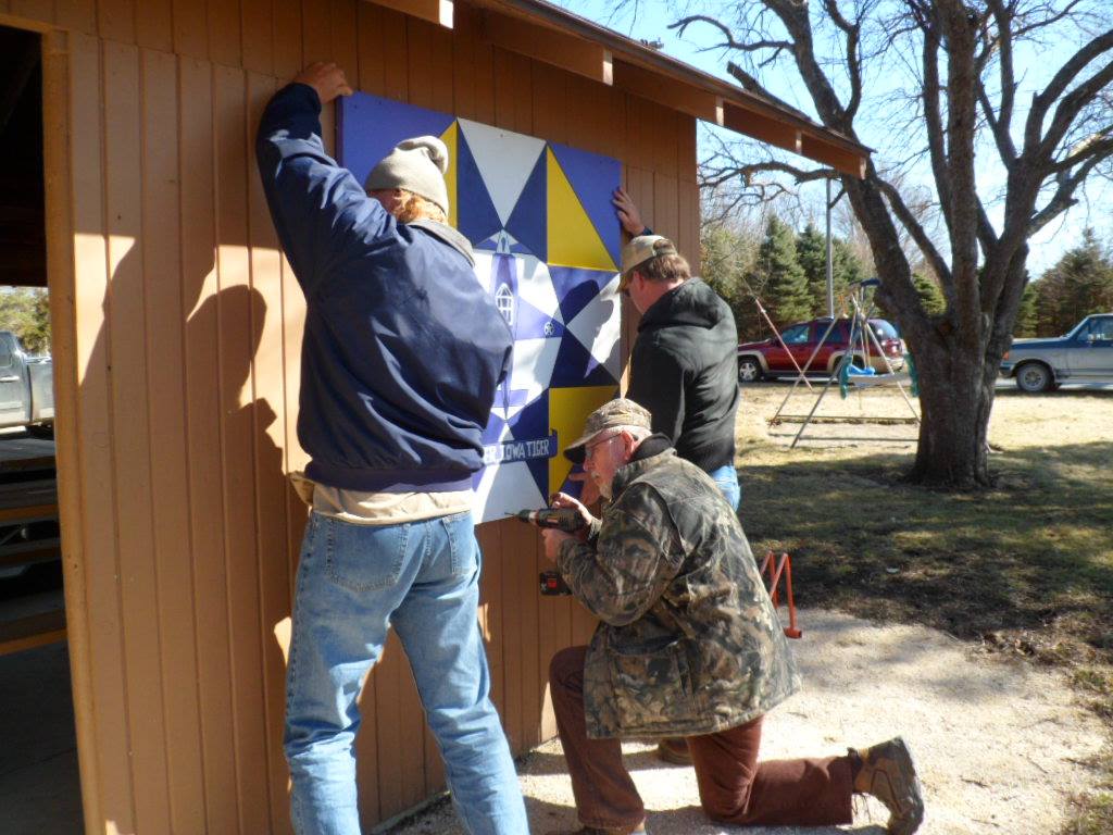 Crews installing barn quilt at Plover City Park