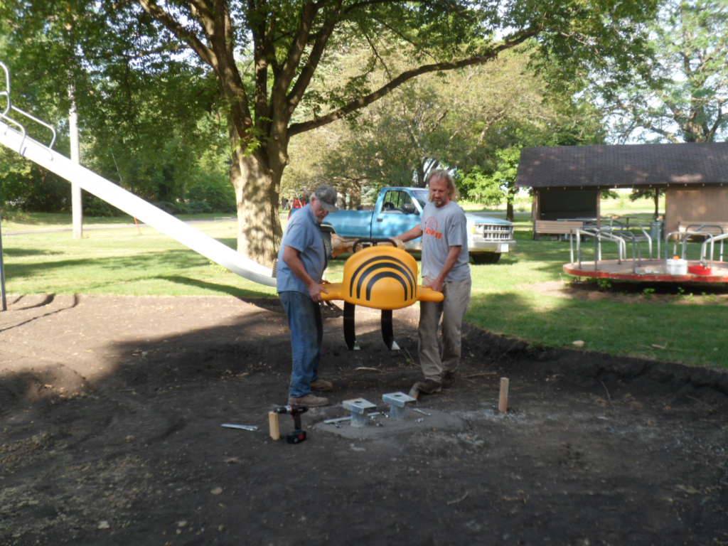 Volunteers installing new playground equipment at Plover City Park